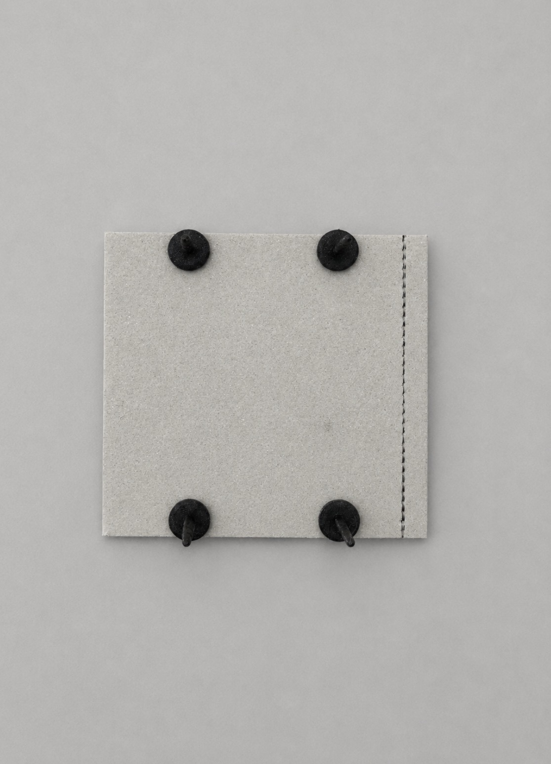 Back of a full M-Plate showing four fasteners and perforated trim guide